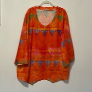 A orange and multicolor designs blouse .
Three-quarter length sleeve, v-neck.